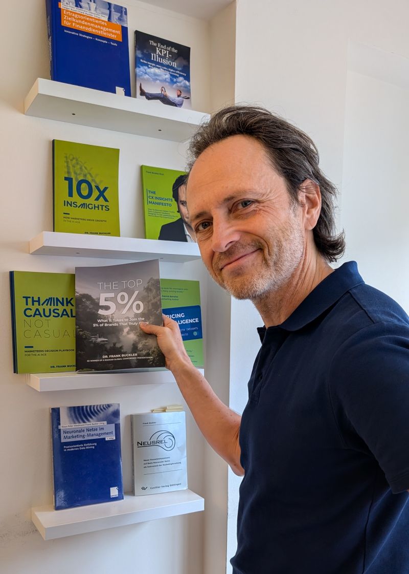 Dr. Frank Buckler with his books, including the new release The Top 5%